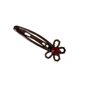 Brown metal snap clip with hollow five-petal flower and a deep red center bead decoration