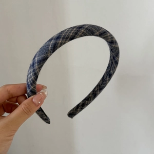 Detail of blue and grey plaid fabric headband with classic checkered textile texture