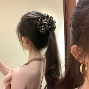 Vintage leopard print chiffon scrunchie for low ponytail styling on female model