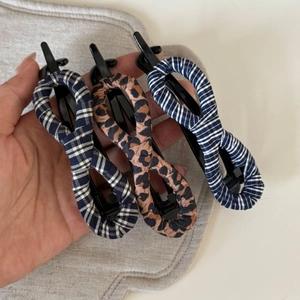 Three-piece hair clip set featuring leopard print and vintage plaid patterns for styling