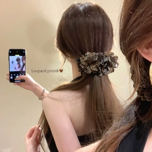 Leopard print flower banana clip for low ponytail styling on a fashion model