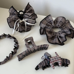 Collection of brown plaid hair accessories including headbands and clips on white background