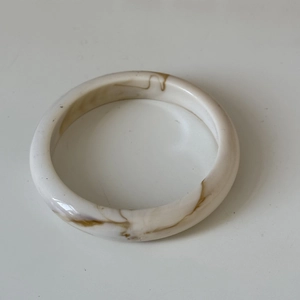 Detailed macro view of retro tortoiseshell resin bangle with vintage marble texture pattern