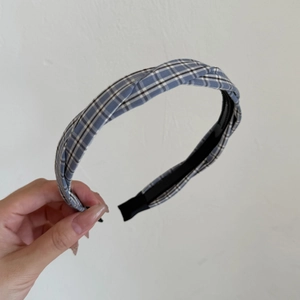 Detailed close-up of blue and white plaid headband with anti-slip inner teeth