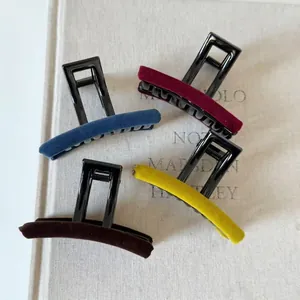 Set of four velvet-covered hair claws in assorted colors with matte resin handle