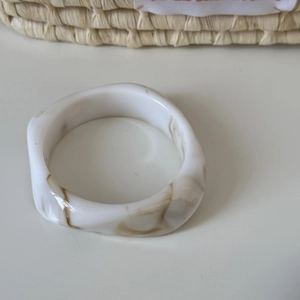 Close-up of marble pattern acrylic resin bangle with vintage geometric irregular design