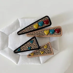 Korean style leopard heart hair clip set with resin geometric design on white background