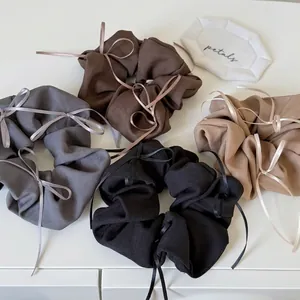 Elegant ballet style hair scrunchies with delicate ribbons in assorted earthy tones