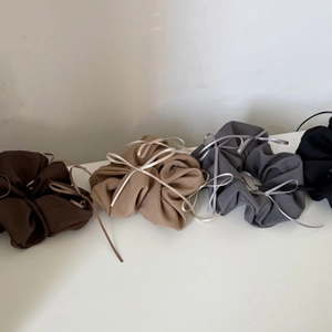 Set of four chiffon bow scrunchies in brown, khaki, grey, and black tones for hair styling