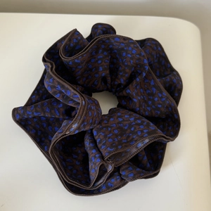Vintage leopard print scrunchie in brown and blue satin fabric for elegant hair styling