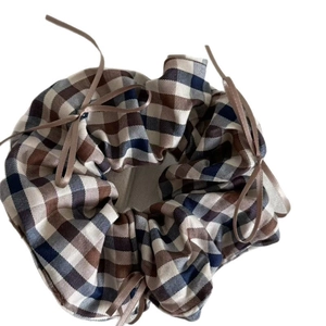 Brown plaid scrunchie with satin bows for elegant ponytail styling on white background