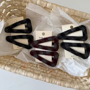 Vintage Haarklammern aus Stoff mit Karomuster in Grau und Rot auf Displaykarte