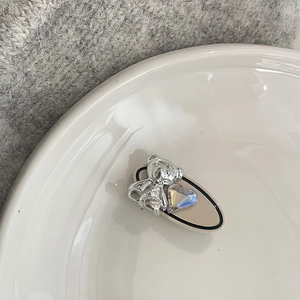 Cute silver bear hair clip with heart gem on beige oval base in Korean style