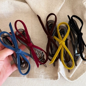 Velvet bow hair clips in multiple colors like burgundy and navy with matte black finish