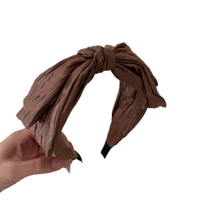 Elegant brown pleated satin headband with a classic bow design for a stylish look