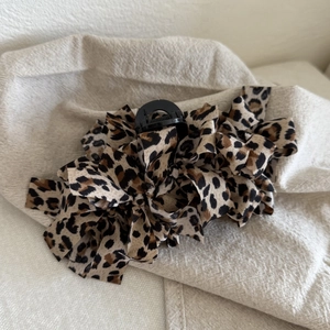Chic leopard print bow hair claw clip made of fabric and durable black plastic