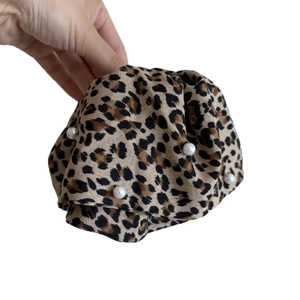 Leopard print hair scrunchie with white pearls and a voluminous pleated fabric design