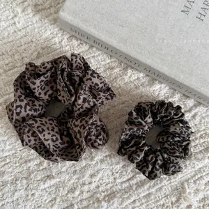 Vintage leopard print scrunchies set in two sizes on minimalist background