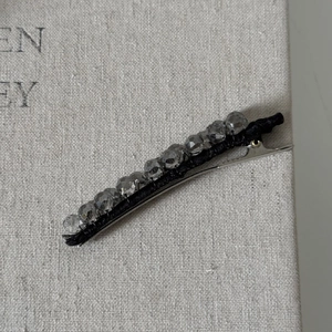 Elegant star hair clip with grey crystal beads on black fabric and silver metal alligator clip