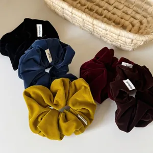 Soft velvet hair scrunchies in multiple colors with handmade tags for bun hairstyles