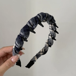 Detail of vintage plaid fabric headband with non-slip inner teeth for secure hair styling