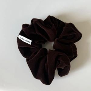 Deep brown velvet milk fleece scrunchie with handmade label for elegant hair styling