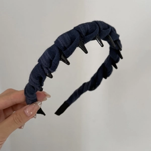Detailed view of dark blue plaid fabric headband with non-slip inner plastic teeth