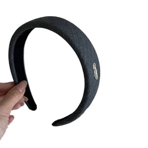 Elegant dark grey striped fabric headband with minimalist gold metal decorative accent