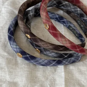 Detail of plaid headbands with vintage gold metal buckles in various autumn colors
