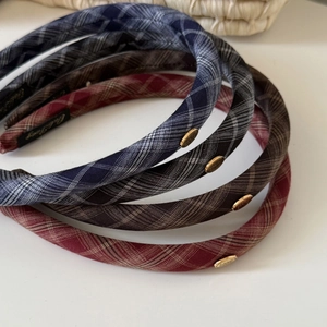 Classic plaid fabric headband set in four colors with a premium gold metal logo accent