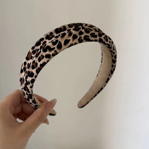 Close-up of wide leopard print headband with non-slip fabric lining for women