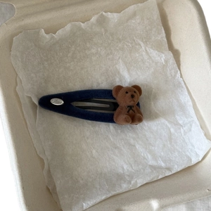 Cute navy flocked bear hair clip with a silver Love plaque on soft white paper