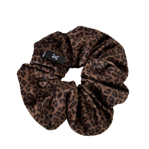 Brown leopard print velvet scrunchie with soft texture and brand logo for bun hairstyles