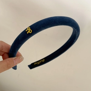 Elegant navy blue velvet headband with yellow bow accent and vintage aesthetic for women