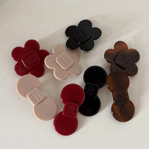 Floral and bow acetate hair clips in burgundy, beige, black, and tortoiseshell patterns
