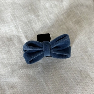 Macro detail of navy blue velvet bow hair claw clip showing soft texture and sturdy grip