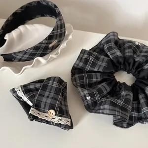 Three-piece black and white plaid hair accessories set including headband, scrunchie and clip