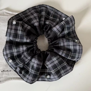 Detail of vintage plaid fabric scrunchie with pearl and rhinestone accents