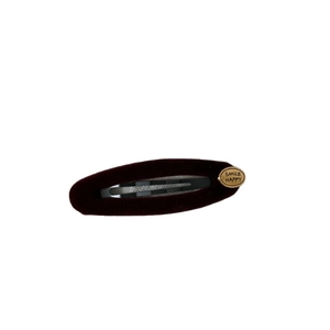 Vintage burgundy velvet oval hair clip with a gold engraved Smile Happy metal plate