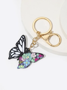 Detail view of acrylic butterfly keychain with floral pattern and gold lobster clasp