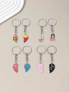 Detail of four pairs of alloy Best Friends keychains featuring burgers, hearts and music notes