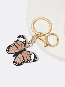 Close-up of golden lobster clasp and colorful printed butterfly acrylic keychain detail