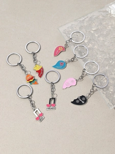 Detail view of colorful enamel keychain charms featuring burgers, music notes and heart puzzles