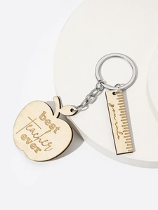 Detail of wooden apple keychain with best teacher ever engraving and ruler charm