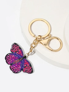 Detail of butterfly keychain with purple enamel wings and gold alloy lobster clasp