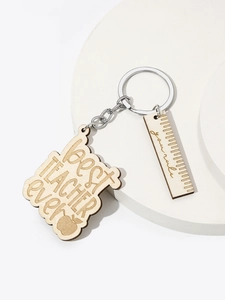 Macro view of wooden teacher keychain set with engraved slogans and ruler charms