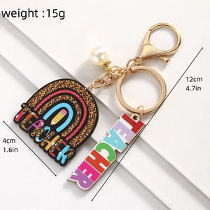 Close-up of Teacher Appreciation keychain with rainbow charm and white pearl detail
