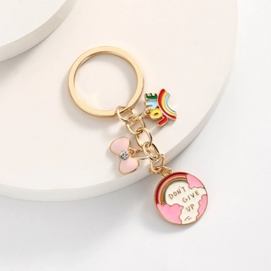 Süßer goldener Schlüsselanhänger mit rosa Schleife, Regenbogen und Erdmotiv-Anhänger