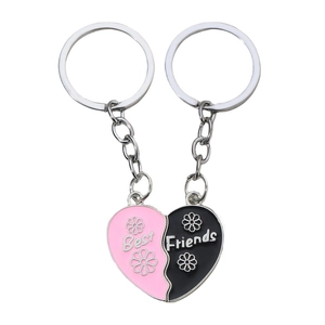 Detail of pink and black Best Friends split heart keychains with floral enamel