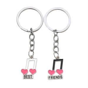 Musical note keychain set with Best Friends engraving and pink hearts on white background